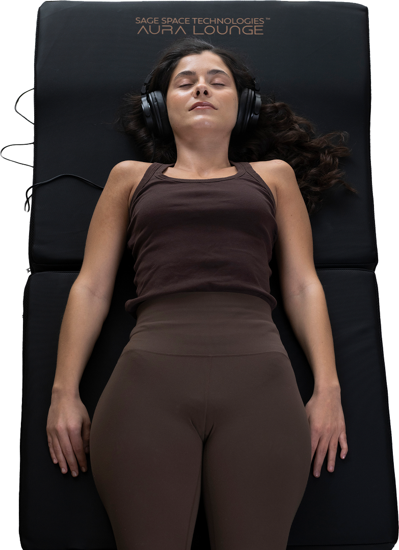 Person lying on Aura Lounge wearing headphones