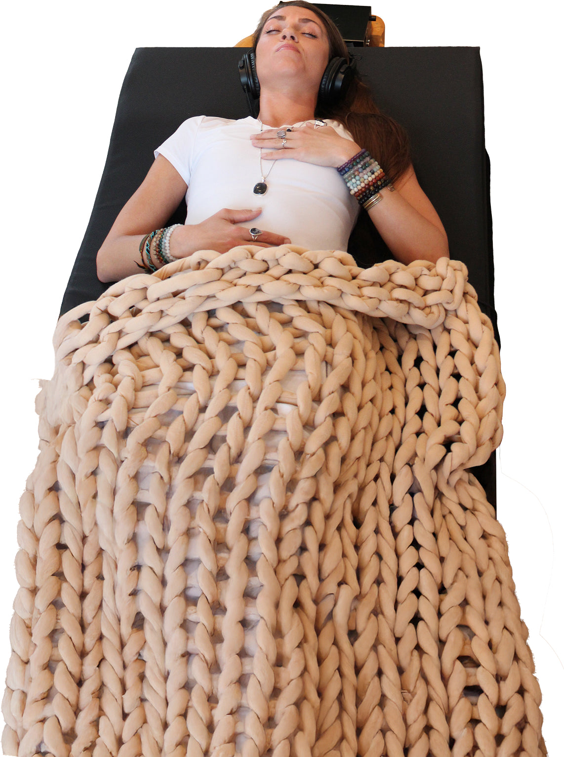 Person lying on Aura Lounge wearing headphones