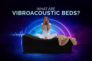 A woman sitting in a meditative pose on a black vibroacoustic bed with glowing blue and purple energy waves in the background.